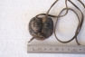 Clay Pendant With Aboriginal Heads Showing